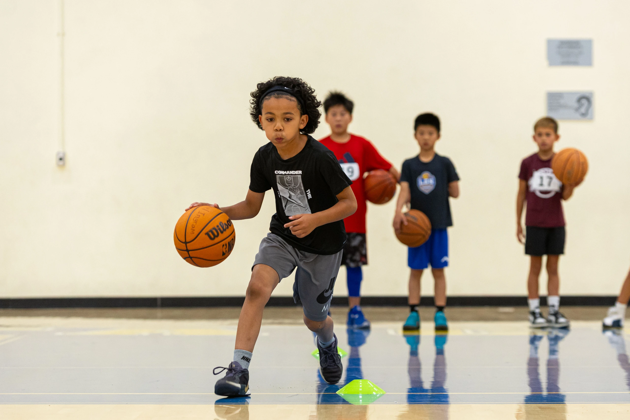 Campers running a drill at the Santa Clara men's basketball camp
