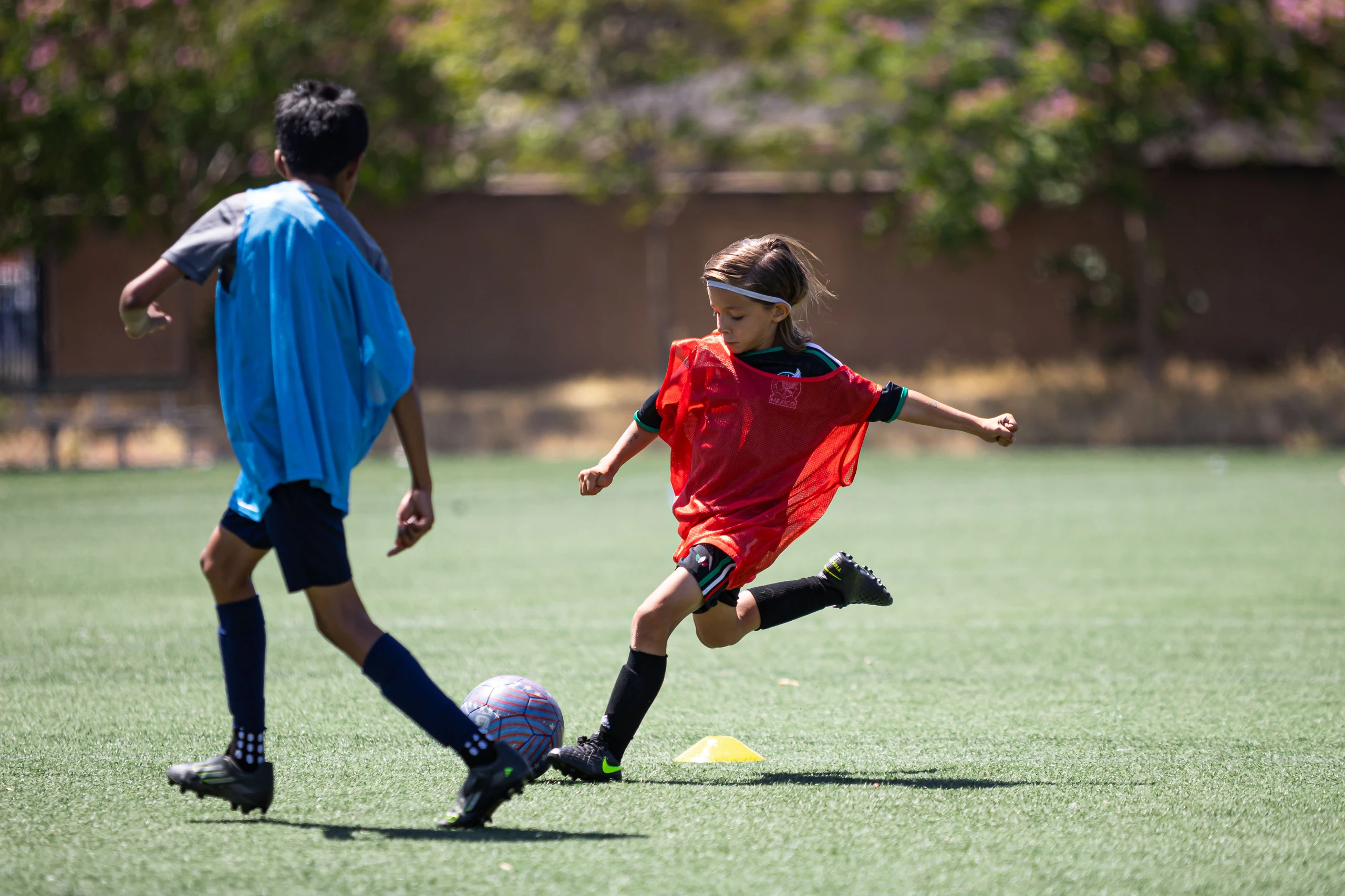 Campers and Santa Clara University players on the turf field