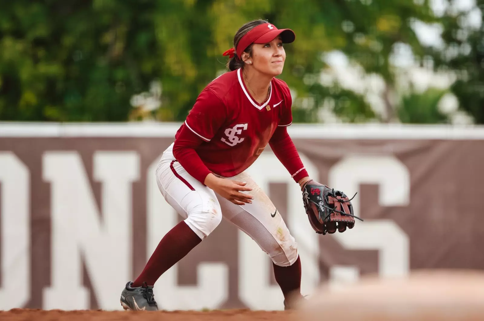 Rebecca Rubio in a fielding stance at shortstop