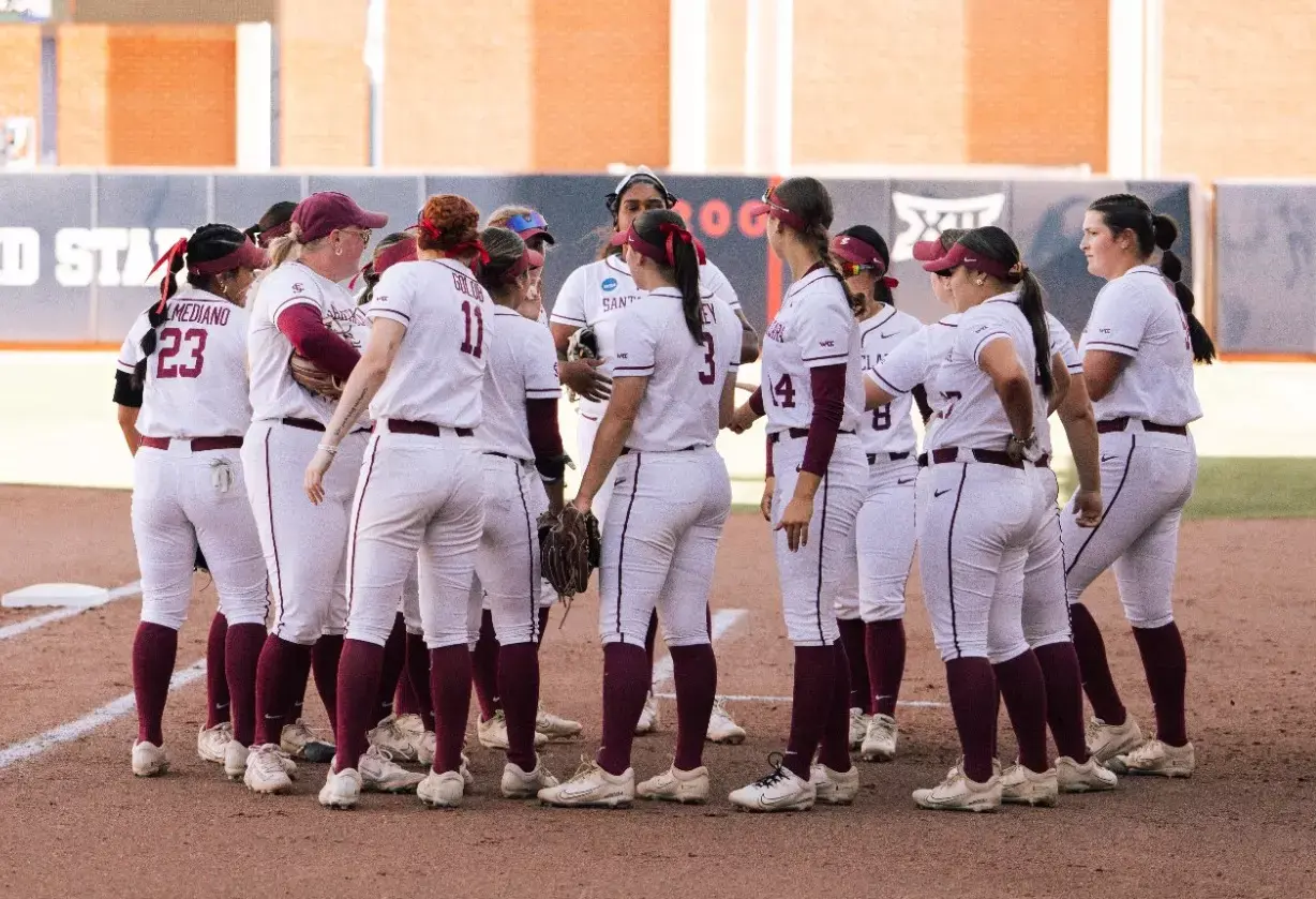 The Santa Clara University softball team gathered in a huddle on the infield