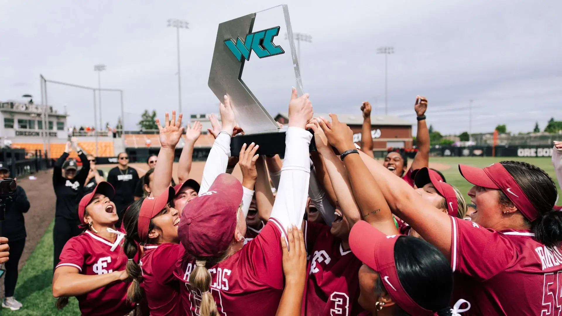 Santa Clara University softball players raising the West Coast Conference Championship trophy