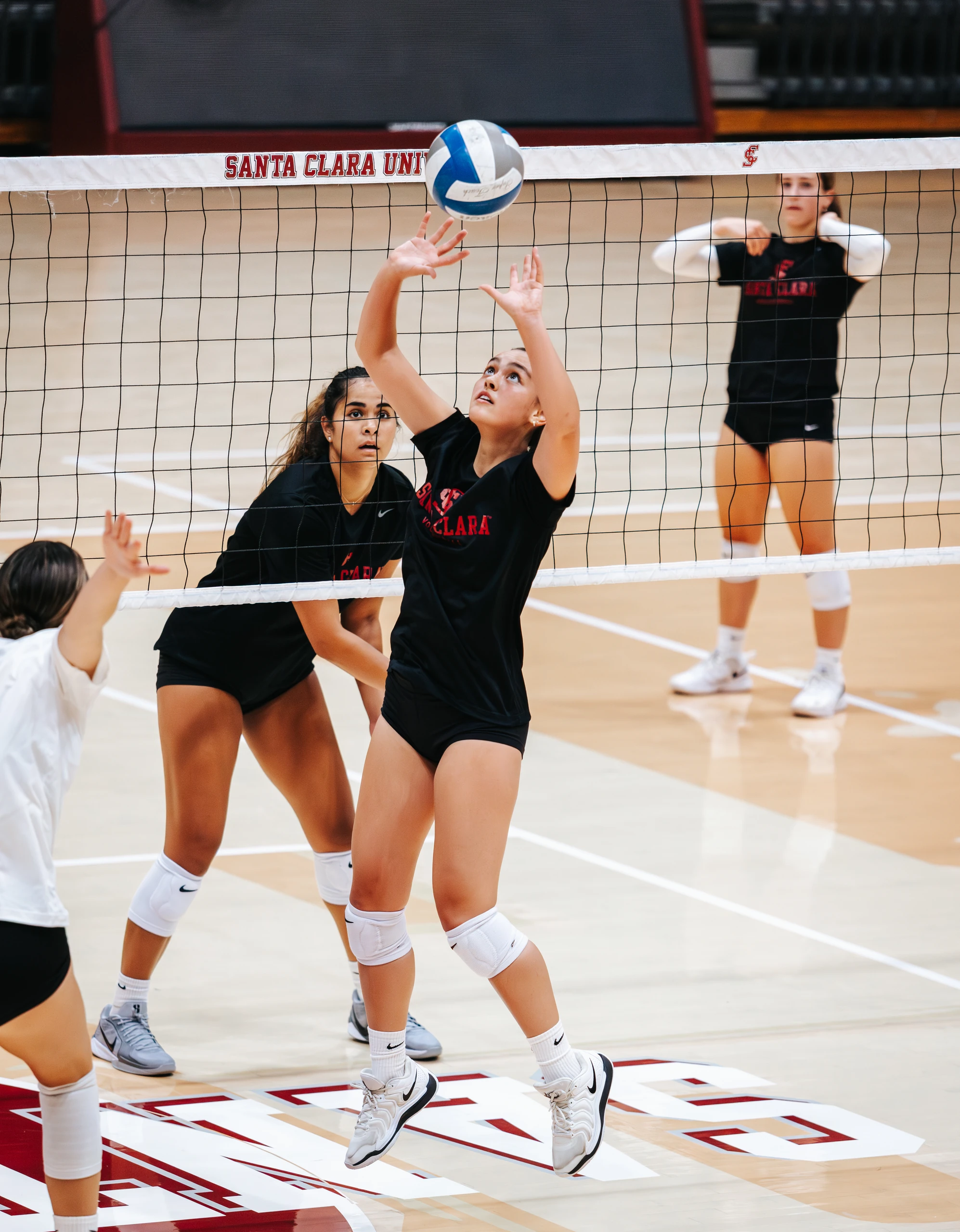 Santa Clara University volleyball players on the court